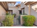 Stunning front entrance with metal gate and lush landscaping at 15240 N Clubgate Dr # 137, Scottsdale, AZ 85254