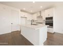 Modern kitchen featuring a large island, white cabinetry, and stainless steel appliances at 17250 W Via Dona Rd, Surprise, AZ 85387