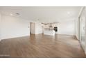 Spacious living room featuring an open concept design and wood-look floors at 17250 W Via Dona Rd, Surprise, AZ 85387