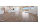 Open-concept living space featuring sleek tile floors, plenty of natural light, and access to the backyard at 17429 W Via Dona Rd, Surprise, AZ 85387