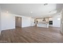Bright and airy living space with an open floor plan connecting the kitchen and living areas at 17429 W Via Dona Rd, Surprise, AZ 85387