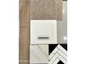 Selection of interior finish samples featuring wood, carpet, tile, and cabinet details at 17429 W Via Dona Rd, Surprise, AZ 85387