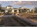 Exterior view of the community clubhouse with an inviting facade, hardscape, and manicured landscaping at 17560 W Crawfordsville Dr, Surprise, AZ 85388
