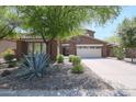 Charming two-story home features a concrete driveway and manicured desert landscaping at 17981 W Agave Rd, Goodyear, AZ 85338