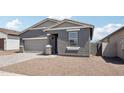 Charming single-story home featuring a two-car garage, neutral color scheme, and well-maintained gravel landscaping at 18256 W La Senda Dr, Surprise, AZ 85387