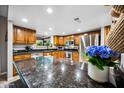 Well-lit kitchen featuring custom cabinets, stainless steel appliances, granite countertops, and a view of the outdoors at 2066 E Lockwood St, Mesa, AZ 85213
