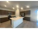 Modern kitchen featuring a central island, stainless steel appliances, and sleek cabinetry at 25348 W Bowker St, Buckeye, AZ 85326
