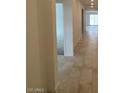 Bright hallway featuring neutral tile flooring and an open layout at 25354 W Bowker St, Buckeye, AZ 85326