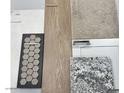 Selection of interior finishes featuring hexagon tile, wood grain plank, granite countertop, neutral carpet and white cabinets at 28922 N 174Th Ln, Surprise, AZ 85387