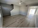 Open-concept living room showcasing new floors and bright, neutral walls at 3840 N 43Rd Ave # 71, Phoenix, AZ 85031
