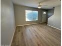 Bright living room featuring new floors, a large window, and a ceiling fan at 3840 N 43Rd Ave # 71, Phoenix, AZ 85031