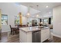 Bright kitchen with granite countertops, stainless appliances and an island with sink overlooking the dining and living area at 3855 S Mcqueen Rd # 101, Chandler, AZ 85286