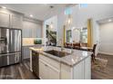 This modern kitchen has stainless appliances, granite countertops and an island with sink and room for seating at 3855 S Mcqueen Rd # 101, Chandler, AZ 85286