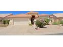 Charming single-story home with a well-manicured desert landscape, a two-car garage, and a welcoming entrance at 3928 N 151St Ave, Goodyear, AZ 85395