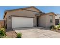 Attractive single-story home featuring a white garage door, a neutral facade, and low-water landscaping at 47859 W Moeller Rd, Maricopa, AZ 85139