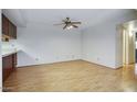 Open-concept dining area with laminate floors and a modern ceiling fan at 5807 W Acoma Dr, Glendale, AZ 85306