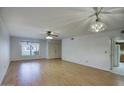 Spacious living room showcasing wood floors, natural light, and contemporary ceiling fans at 5807 W Acoma Dr, Glendale, AZ 85306