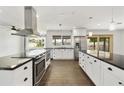 Bright, modern kitchen features white cabinets, stainless steel appliances, and hardwood floors at 6027 E Spring Rd, Scottsdale, AZ 85254
