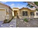 Inviting single-story home exterior with desert landscaping and a covered entrance, offering curb appeal at 7332 W Pershing Ave, Peoria, AZ 85381