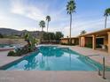 Inviting backyard pool with palm trees offering a relaxing oasis with mountain views at 7816 N 47Th St, Paradise Valley, AZ 85253