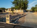 Attractive property features lovely landscaping, desert accents, and mature trees, enhancing curb appeal at 7969 S 172Nd St, Queen Creek, AZ 85142