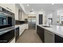 Gourmet kitchen with stainless steel appliances, a large island, and sleek countertops and cabinetry at 9280 E Thompson Peak Pkwy # 39, Scottsdale, AZ 85255