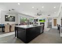 Modern kitchen featuring a large island, stainless steel appliances, and an open floor plan to the living area at 9280 E Thompson Peak Pkwy # 39, Scottsdale, AZ 85255