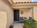 A welcoming front porch featuring comfortable seating and a decorative wreath at 12121 N 129Th Dr, El Mirage, AZ 85335