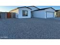 Charming single-story home featuring a white exterior, black trim, and a well-maintained gravel front yard at 15864 S Cherry Hills Dr, Arizona City, AZ 85123