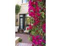 Cozy patio area featuring brick flooring, comfortable seating and lush bougainvillea at 20084 N 103Rd St, Scottsdale, AZ 85255