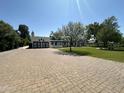 A spacious driveway leads to a white home with a well-manicured lawn and a charming facade at 2311 E Colter St, Phoenix, AZ 85016