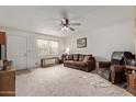 Inviting living room featuring neutral carpet, ceiling fan, and ample natural light at 4501 E Carol Ave # 48, Mesa, AZ 85206