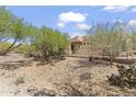 View of the backyard of the home, fenced in with desert landscaping and natural vegetation at 6088 E Knolls N Way, Cave Creek, AZ 85331