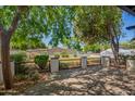 Beautifully landscaped front yard featuring a paved patio and a lush array of trees and shrubbery at 6741 N 10Th St, Phoenix, AZ 85014
