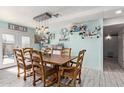 Lovely dining room area with wood floors, natural light, and access to the yard at 7357 W Cheryl Dr, Peoria, AZ 85345