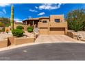 Stunning desert home with a two-car garage, beautiful landscaping, and a charming staircase to the front door at 13554 E Columbine Dr, Scottsdale, AZ 85259