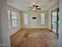 Bright bedroom with ample natural light, ceiling fan, and access to a private balcony at 17749 W Woodrow Ln, Surprise, AZ 85388