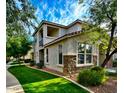 Charming two-story home featuring stone accents, lush landscaping, and a private balcony at 17749 W Woodrow Ln, Surprise, AZ 85388