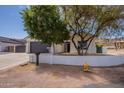 Inviting home showcasing a landscaped front yard and attached two car garage offering curb appeal at 2701 E Caldwell St, Phoenix, AZ 85042