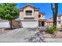 Two-story home with tan stucco, a two-car garage, and well-manicured front yard at 3433 S Chaparral Rd, Apache Junction, AZ 85119