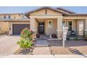 Inviting home with a covered porch, brick paver walkway, desert landscaping, and warm neutral tones at 3871 E Harrison St, Gilbert, AZ 85295