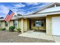 Welcoming front entrance with a charming brick facade and an American flag waving proudly at 4522 E Andora Dr, Phoenix, AZ 85032