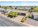 Overhead view of a single-story home with a covered carport, neat landscaping, and neighborhood streets at 6631 E Dallas St, Mesa, AZ 85205