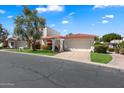 Charming home exterior features a red tile roof, lush landscaping, and inviting curb appeal at 7644 E Sandalwood Dr, Scottsdale, AZ 85250