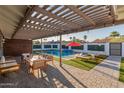 Inviting backyard features a pool, lounge chairs, and an outdoor seating area under a pergola at 8522 E Virginia Ave, Scottsdale, AZ 85257
