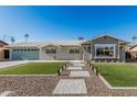 Charming home with a well-manicured lawn, paver pathway, and neutral-toned exterior at 8522 E Virginia Ave, Scottsdale, AZ 85257