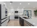 Bright kitchen with modern white cabinets, stainless steel appliances, and a spacious center island at 8522 E Virginia Ave, Scottsdale, AZ 85257