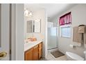 Bright bathroom with a walk-in shower, modern vanity, and neutral tile flooring at 10410 N Cave Creek Rd # 1100, Phoenix, AZ 85020