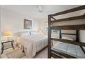 Bedroom features a bunk bed and a queen size bed with neutral tones and a ceiling fan at 10410 N Cave Creek Rd # 1100, Phoenix, AZ 85020