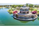 Picturesque lakefront community featuring a gazebo, walking trails, and lush landscaping at 1104 E Tekoa Ave, Gilbert, AZ 85298